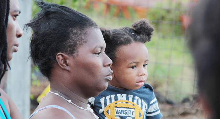 Nolly Jack'S Girlfriend, Lynda Thomas, Holds Their 1-Year-Old Son At The Crime Scene On Saturday. (Iwn Photo)
