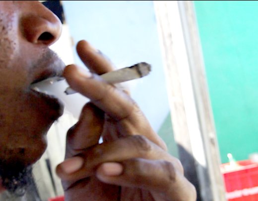 A man smokes a marijuana cigarette in St. Vincent. (IWN file photo)