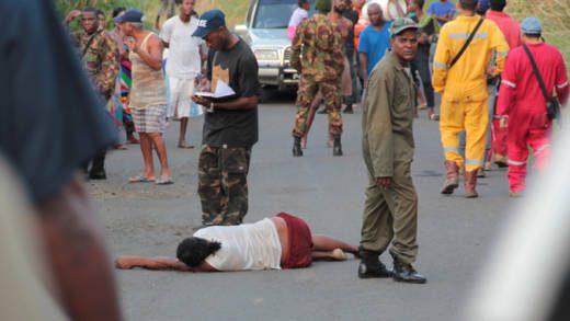 Police officers conduct investigation as the body of Nolly Jack lies on the road in Lowmans Bay. (IWN photo)
