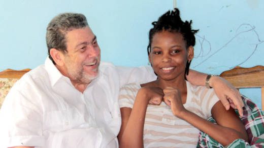 Prime Minister Ralph Gonsalves chats with Sweet-I Robertson at her home in Chateaubelair on Saturday. (IWN photo) 