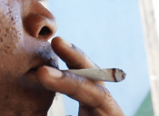 A man smokes marijuana in St. Vincent. (IWN file photo)