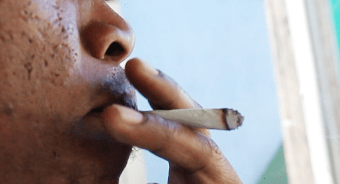 A man smokes marijuana in St. Vincent. (IWN file photo)