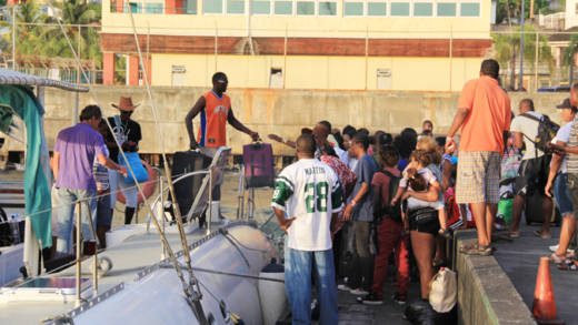 Passengers disembark a catamaran that ferried them from Union Island to Kingstown on Monday. (IWN photo)