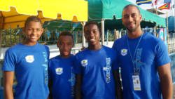 From left: Vincentian medal winner Shné Joachim, along with fellow swimmers, Shane Cadogan and Nikolas Sylvester, and their coach, Kyle Dougan.