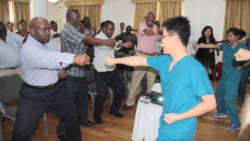 Ministry of Health officials and other persons participate in a demonstration of Chinese qigong, led by Chinese medicine expert Dr. Shun-chang Ian Chang, right in Kingstown on Tuesday. (IWN photo) 