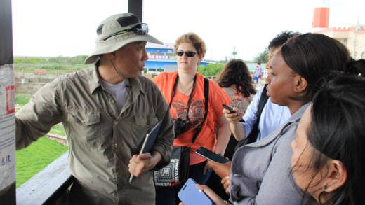 International journalists interact with a conservationist at Goamei Wetlands in central Taiwan on Wednesday. (IWN Photo)