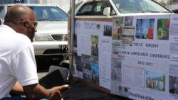 A man looks at a biodiversity display in Kingstown. Click for more photos. (IWN photo)
