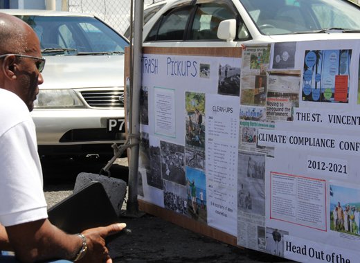 A man looks at a biodiversity display in Kingstown. Click for more photos. (IWN photo)