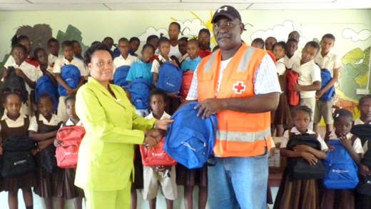 Headmistress at the Buccament (Dubois) Govt School, Susan Abraham, left, receives the donation from Bernard Morgan, president of the SVG Red Cross.