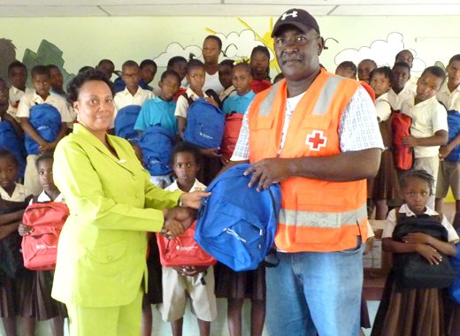 Headmistress at the Buccament (Dubois) Govt School, Susan Abraham, left, receives the donation from Bernard Morgan, president of the SVG Red Cross.