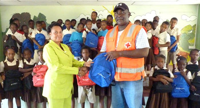 Headmistress at the Buccament (Dubois) Govt School, Susan Abraham, left, receives the donation from Bernard Morgan, president of the SVG Red Cross.