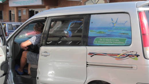 A man boards in Kingstown a taxi that features an element of Vincentian tourism. (IWN photo)