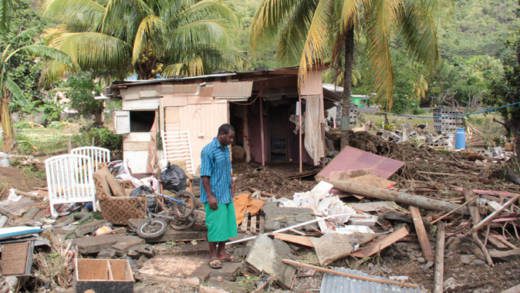 A Buccament Bay resident survey damage after the Christmas Eve trough system. (IWN photo)