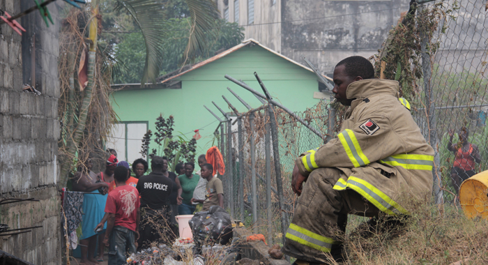 A fire fighter rests after the blaze was brought under control. (IWN photo)