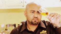 Seon Ballah of St. Vincent Distillers assessing rum.