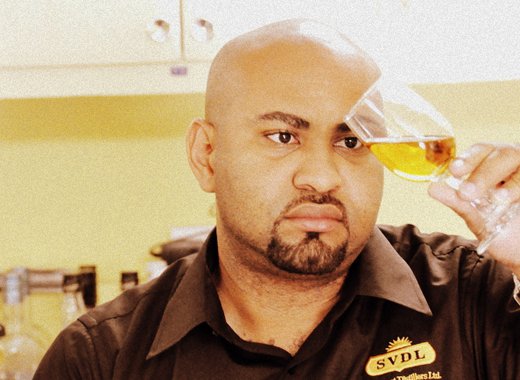 Seon Ballah of St. Vincent Distillers assessing rum.