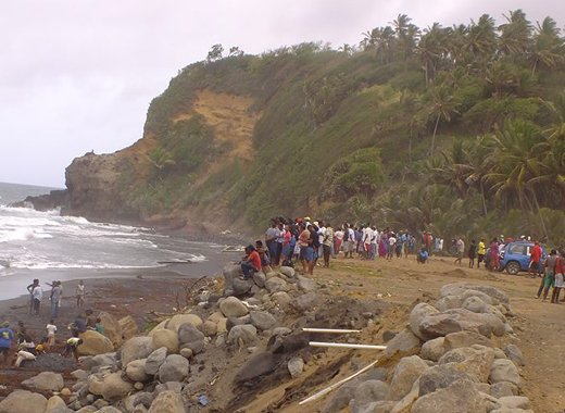 Persons gather on shore in San Souci, where the father and son went missing. (Photo: Manson Shortte/Facebook)