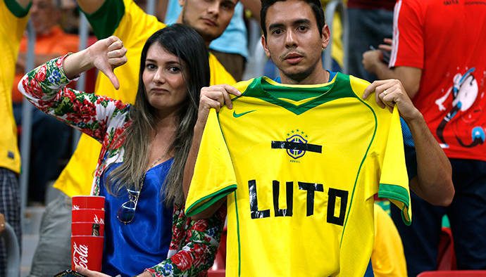 Fans hold up a Brazil jersey reading, "Mourn" during the 2014 World Cup third-place playoff between Brazil and the Netherlands. (Reuters/Jorge Silva)