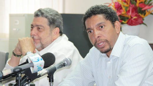 Minister of Telecommunications, Sen. Camillo Gonsalves, foreground, and Prime Minister Ralph Gonsalves are aware of FLOW's customers' complaints. (IWN photo)