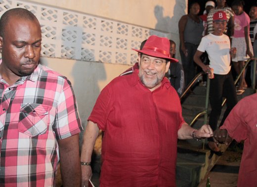 PM Gonsalves, centre, fist-bumps a man after the ULP's candidate selection meeting in Vermont on Saturday. (IWN photo) 
