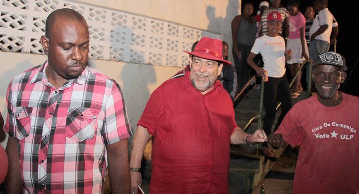 PM Gonsalves, centre, fist-bumps a man after the ULP's candidate selection meeting in Vermont on Saturday. (IWN photo) 