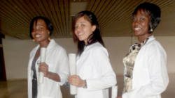 Physicians Arianne Duncan, Joy Walters and Sharmel Frederick proudly pose with their diplomas which qualified them to join the "Army of White Coats".