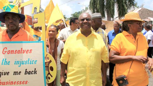 Leader of the Opposition Arnhim Eustace, centre, leads an NDP protest march in 2013. (IWN photo)