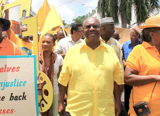 Leader of the Opposition Arnhim Eustace, centre, leads an NDP protest march in 2013. (IWN photo)