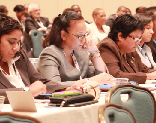 Persons use mobile devices during a session in The Bahamas in which service providers suggested that some apps be blocked.