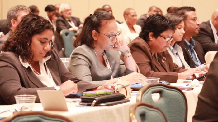 Persons use mobile devices during a session in The Bahamas in which service providers suggested that some apps be blocked.