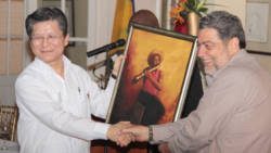 Prime Minister Ralph Gonsalves presents a painting to Ambassador Weber Shih. (IWN photo)