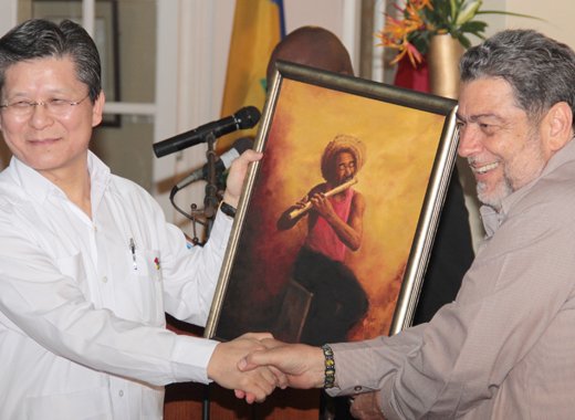 Prime Minister Ralph Gonsalves presents a painting to Ambassador Weber Shih. (IWN photo)