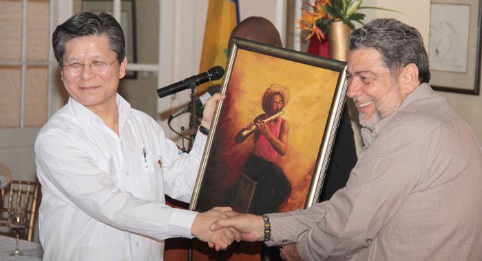 Prime Minister Ralph Gonsalves presents a painting to Ambassador Weber Shih. (IWN photo)