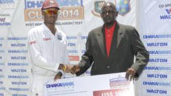 Man of the match Kraigg Brathwaite, left, who scored 212, receives cheque from former West Indies pacer Ian Allen (WICB Media Photo/Randy Brooks)