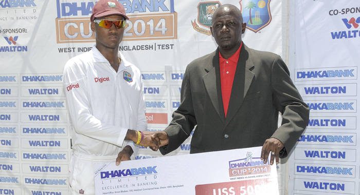 Man of the match Kraigg Brathwaite, left, who scored 212, receives cheque from former West Indies pacer Ian Allen (WICB Media Photo/Randy Brooks)