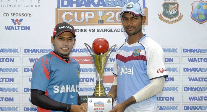 Tightest hold: Captains Mushfiqur Rahim (Ban) and Denesh Ramdhin (WI) pose with Dhaka Bank Trophy.