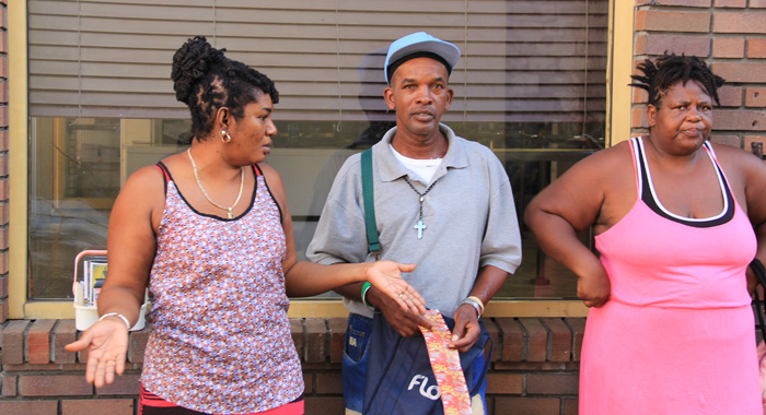 Davie Williams, left, discusses the situation with other vendors. in Middle Street. (IWN photo)
