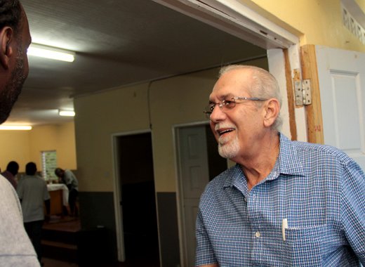 Sen. Julian Francis, right, is greeted by homeowner Donnie Collins as he arrives at the meeting on Saturday. (IWN photo)