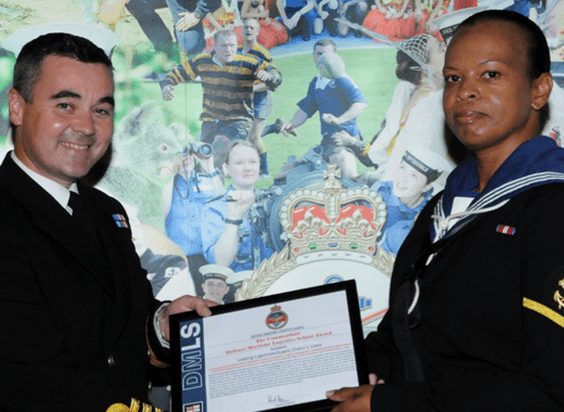 Vincentian Lovita Lewis, left, receiving most outstanding award from Commander Royal Navy, Richard Harris.