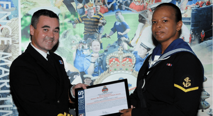 Vincentian Lovita Lewis, left, receiving most outstanding award from Commander Royal Navy, Richard Harris.