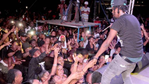Persons react as Popcaan performs at Arthur Guinness Day celebrations in Kingstown. (IWN photo) 