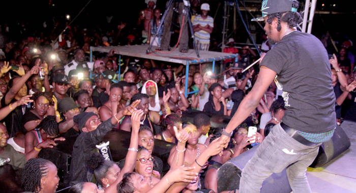 Persons react as Popcaan performs at Arthur Guinness Day celebrations in Kingstown. (IWN photo) 