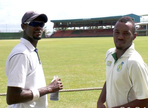 Sunil Ambris, right, chats with CCC's Akeem Dewar at Arnos Vale in June 2014. (Photo: Glenford Prescott/IWN)