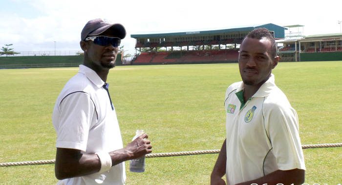 Sunil Ambris, right, chats with CCC's Akeem Dewar at Arnos Vale in June 2014. (Photo: Glenford Prescott/IWN)