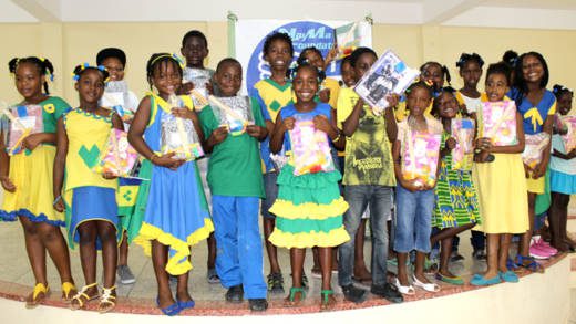 Children pose with the items donated by Tizana Goodluck-Hedge.