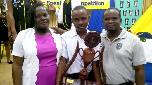 2014 secondary school public speaking champion Eric February poses with his parents and his trophy .