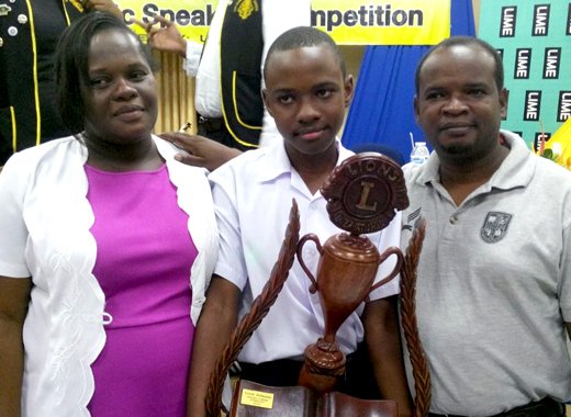 2014 secondary school public speaking champion Eric February poses with his parents and his trophy .