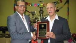 Garnet Brisbane receives his Hall of Fame Award from Charles Pais, president of the Quebec Cricket Foundation.