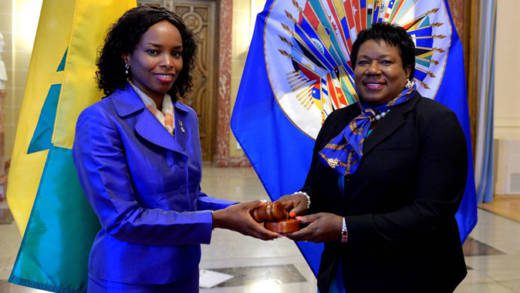 Outgoing Chair, Ambassador Sonia Johnny of St. Lucia, left, hands over chairmans gavel to incoming chair, Ambassador La Celia A. Prince.
