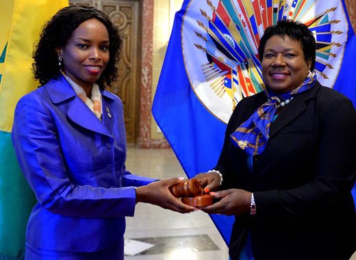 Outgoing Chair, Ambassador Sonia Johnny of St. Lucia, left, hands over chairmans gavel to incoming chair, Ambassador La Celia A. Prince.